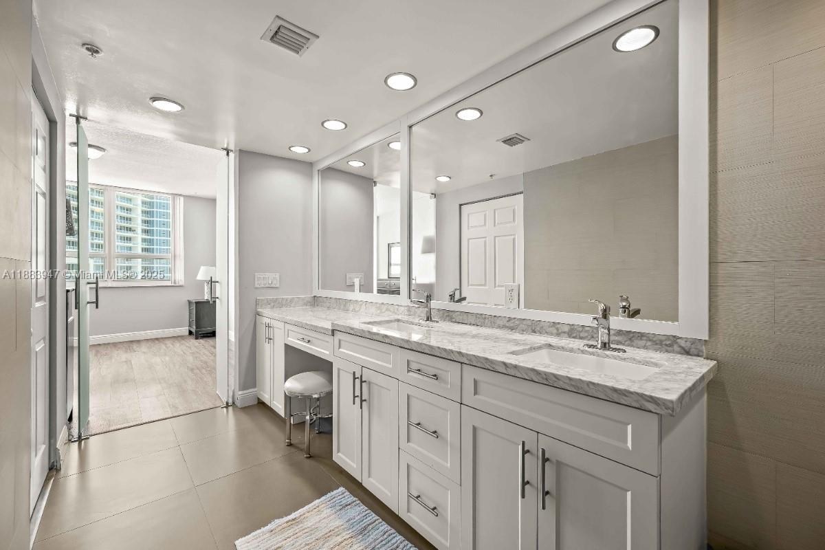 2000 North Bayshore Drive, Unit 1105 Miami, FL 33137 - Photo 18 of 29 a bathroom with a granite countertop sink mirror and double