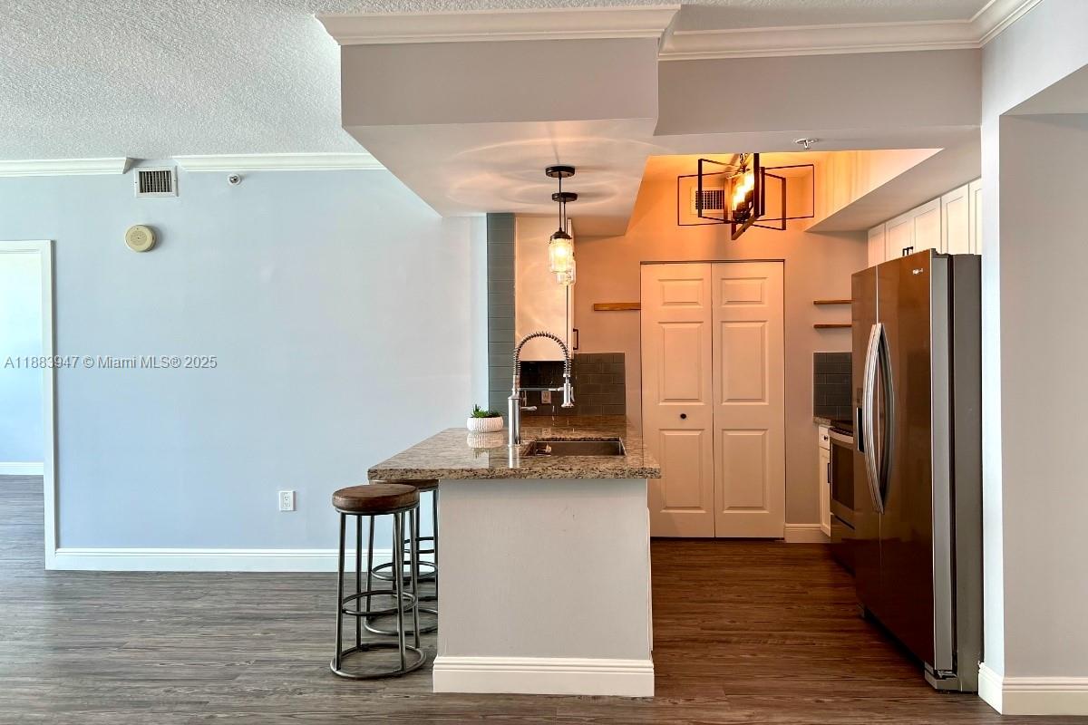 2000 North Bayshore Drive, Unit 1105 Miami, FL 33137 - Photo 7 of 29 a kitchen with stainless steel appliances a refrigerator and wooden floor
