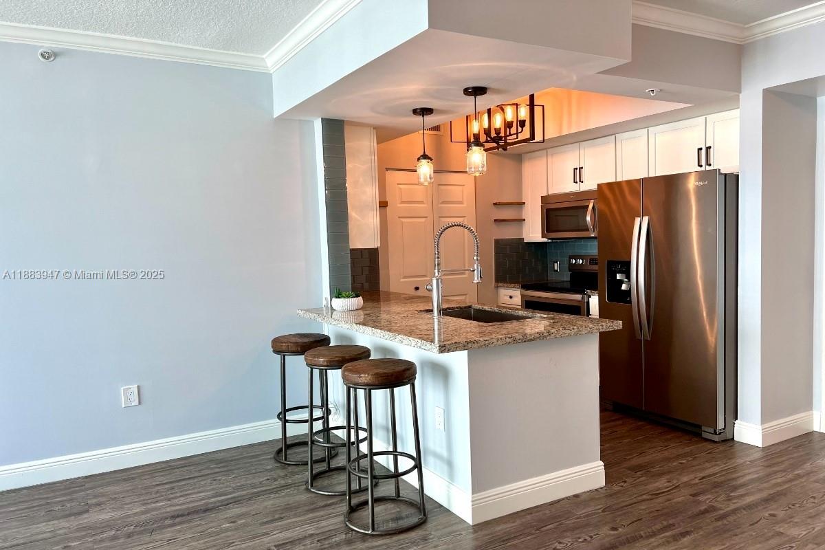 2000 North Bayshore Drive, Unit 1105 Miami, FL 33137 - Photo 8 of 29 a kitchen with stainless steel appliances granite countertop a refrigerator and a stove top oven