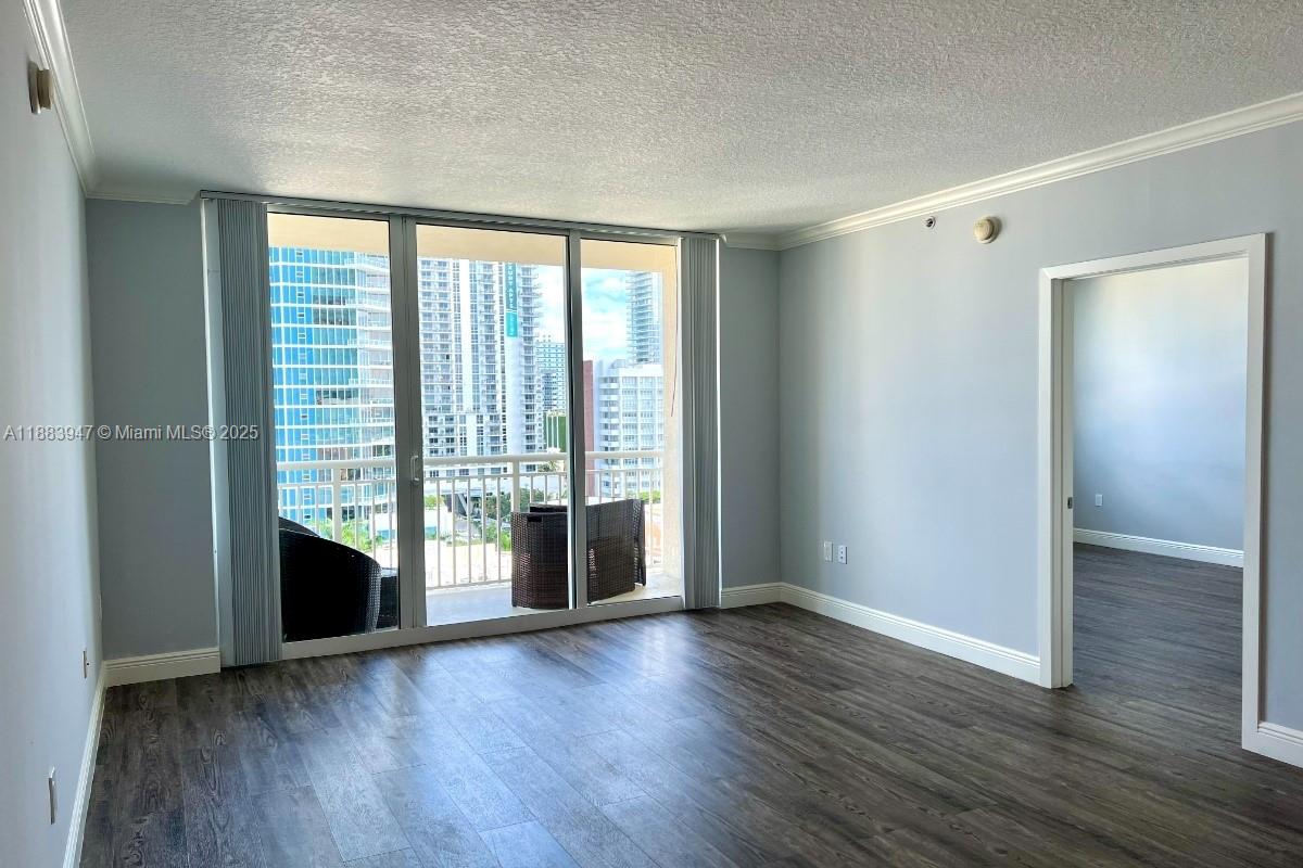 2000 North Bayshore Drive, Unit 1105 Miami, FL 33137 - Photo 9 of 29 a view of an empty room with wooden floor and a window