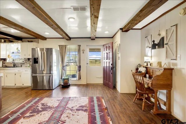 a view of kitchen with furniture and a refrigerator