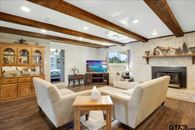 a living room with fireplace furniture and a flat screen tv