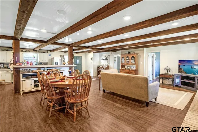 a dining room with furniture and wooden floor