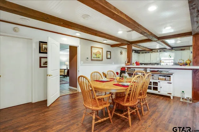 a dining room with furniture and wooden floor
