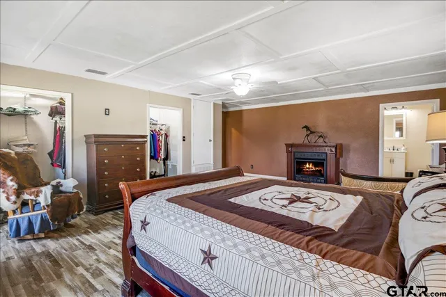 a bedroom with a bed and a fireplace