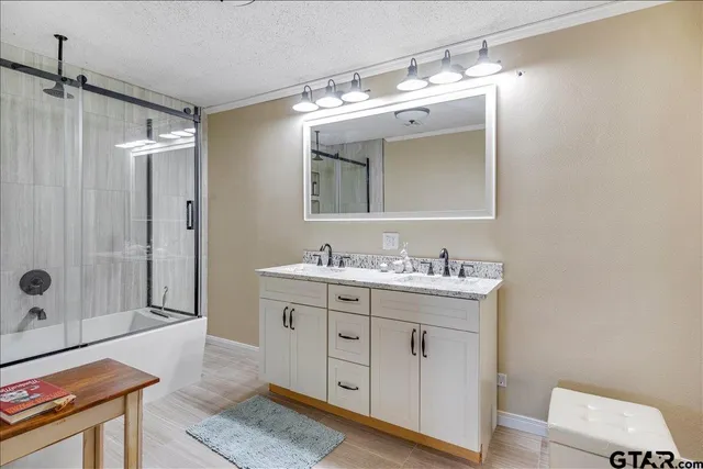 a spacious bathroom with a granite countertop sink mirror and double