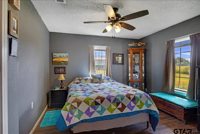 a bedroom with a bed a dresser and a window