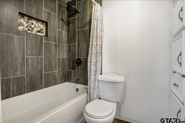 a bathroom with a toilet and shower