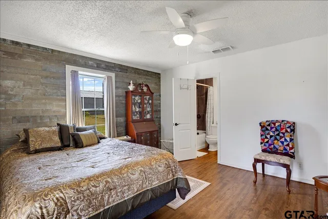 a bedroom with a bed and a dresser