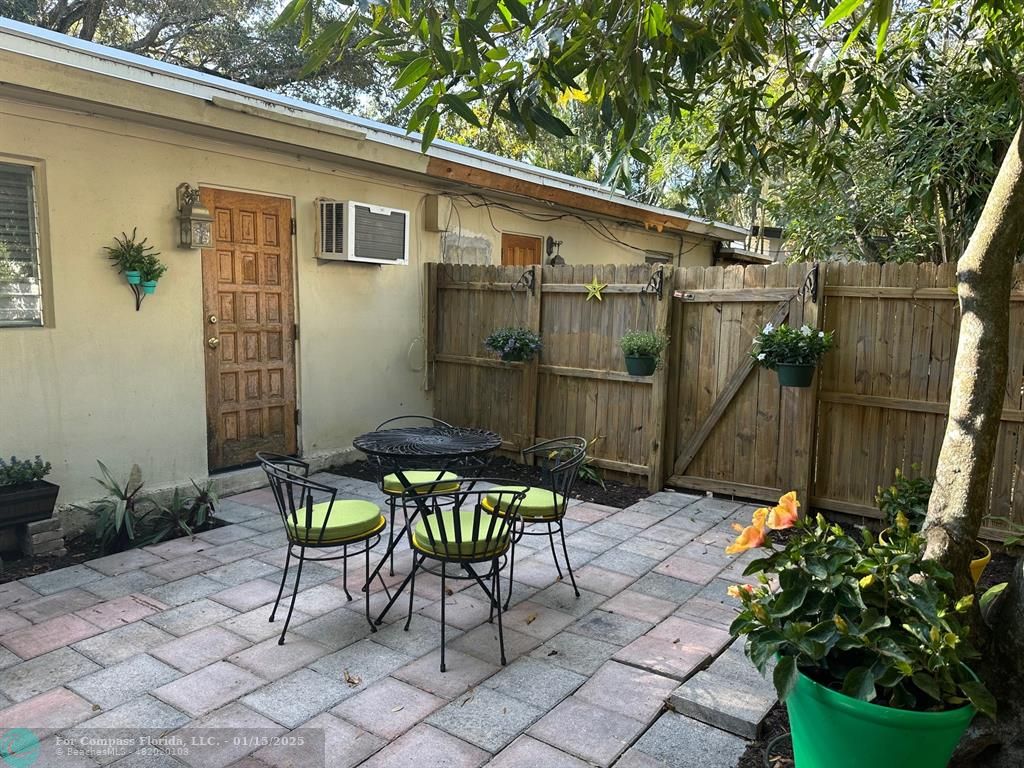 1605 Southwest 25th Street, Unit 4 Fort Lauderdale, FL 33315 - Photo 13 of 14 a patio with table and chairs and potted plants