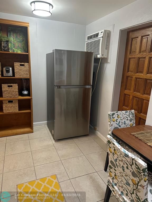 1605 Southwest 25th Street, Unit 4 Fort Lauderdale, FL 33315 - Photo 3 of 14 a kitchen with stainless steel appliances granite countertop a refrigerator and a stove