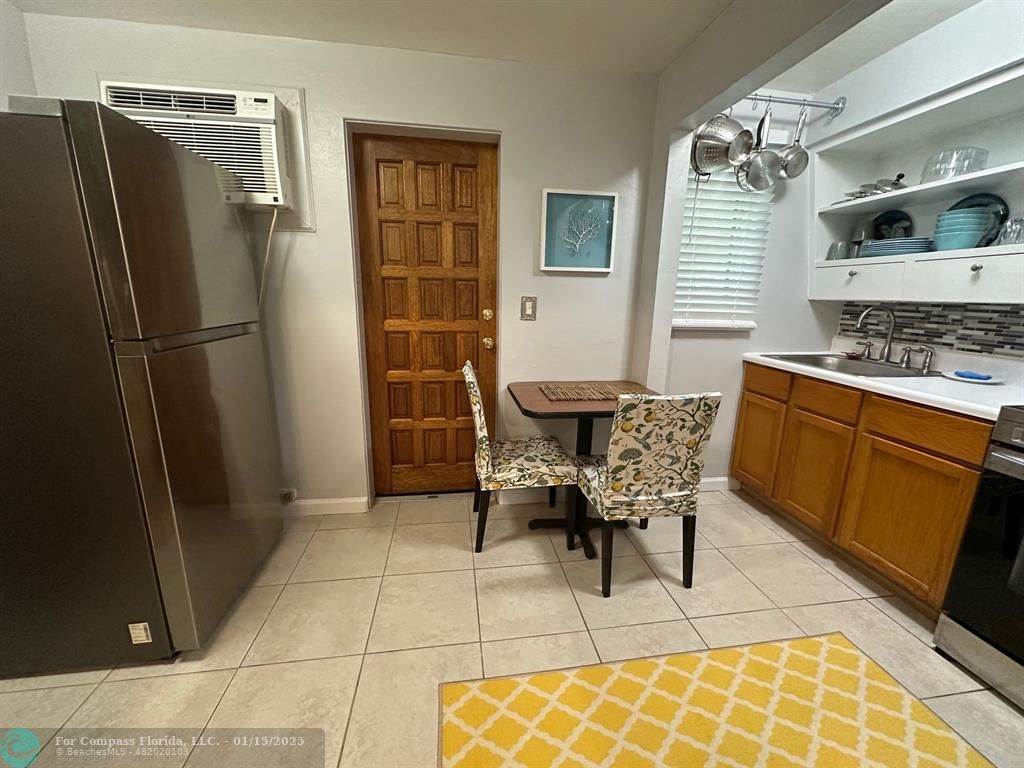 1605 Southwest 25th Street, Unit 4 Fort Lauderdale, FL 33315 - Photo 5 of 14 a dining room with furniture and a kitchen