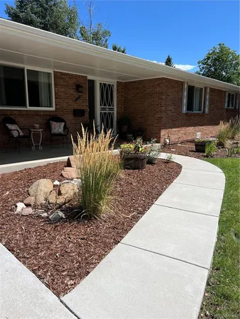 a view of a house with backyard sitting area and furniture