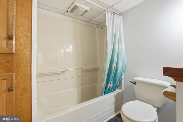 a white toilet sitting next to a bathroom sink