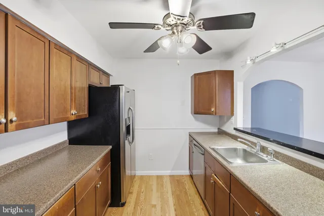 a kitchen with a sink appliances and cabinets