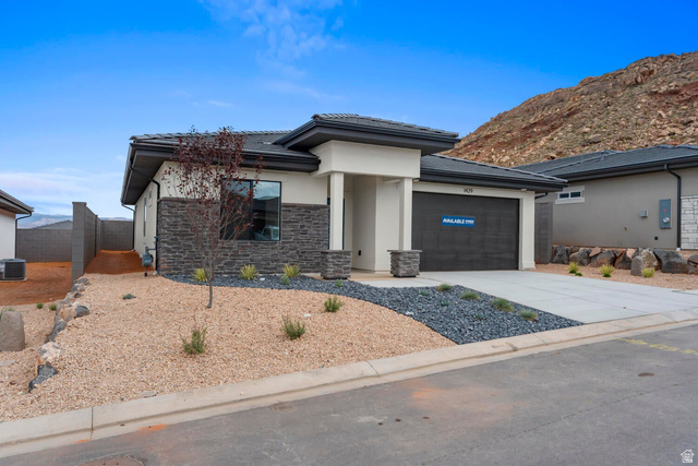 1624 South Staircase Way, Unit 4183 Washington, UT 84780 - Photo 1 of 47 Contemporary single-story exterior featuring a dark gray tile roof, light stucco, and dark stacked stone accents