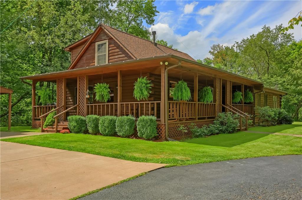 1246 West Lancaster Road Harmony, PA 16037 - Photo 1 of 50 Pristine & updated 1.5 story LOG HOME features 4 beds/2.5 baths/covered front & side porches & XL 2 car garage w/heat & H2O.