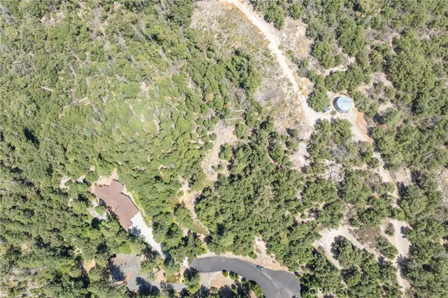 a view of a lake with a yard and mountain in the background