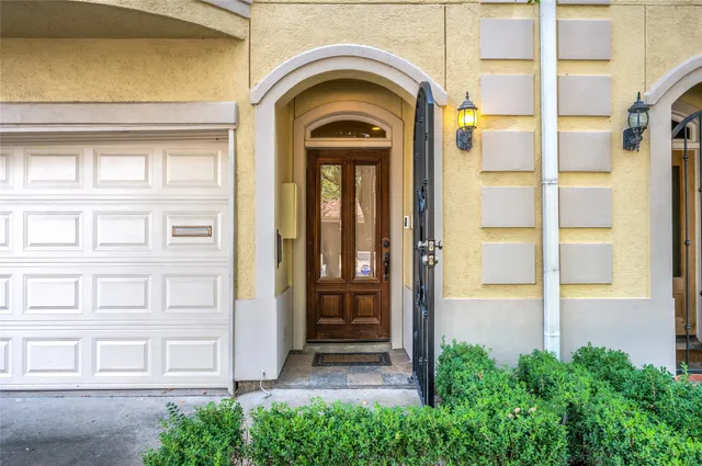 a view of a brick house with large windows