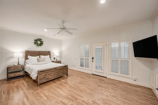 a spacious bedroom with a bed and a flat screen tv