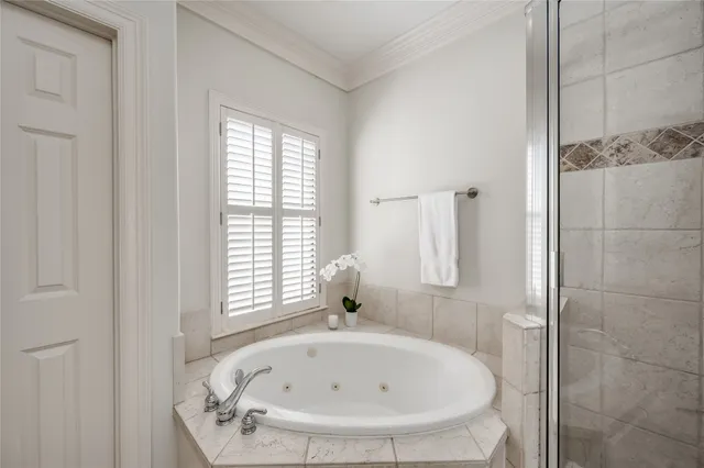 a white bath tub sitting in a bathroom next to a window