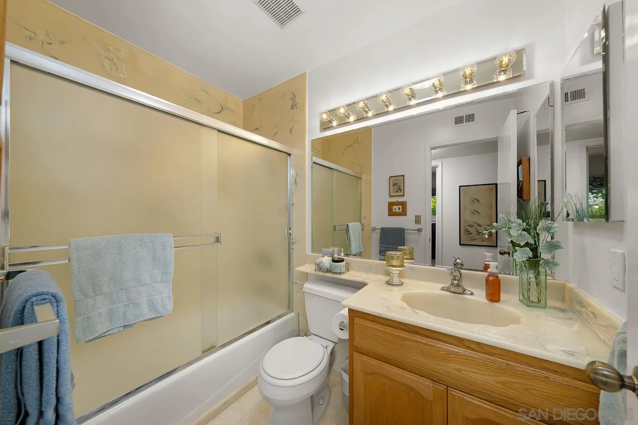 2711 South Barcelona Street Spring Valley, CA 91977 - Photo 14 of 38 a bathroom with a granite countertop sink mirror vanity and toilet