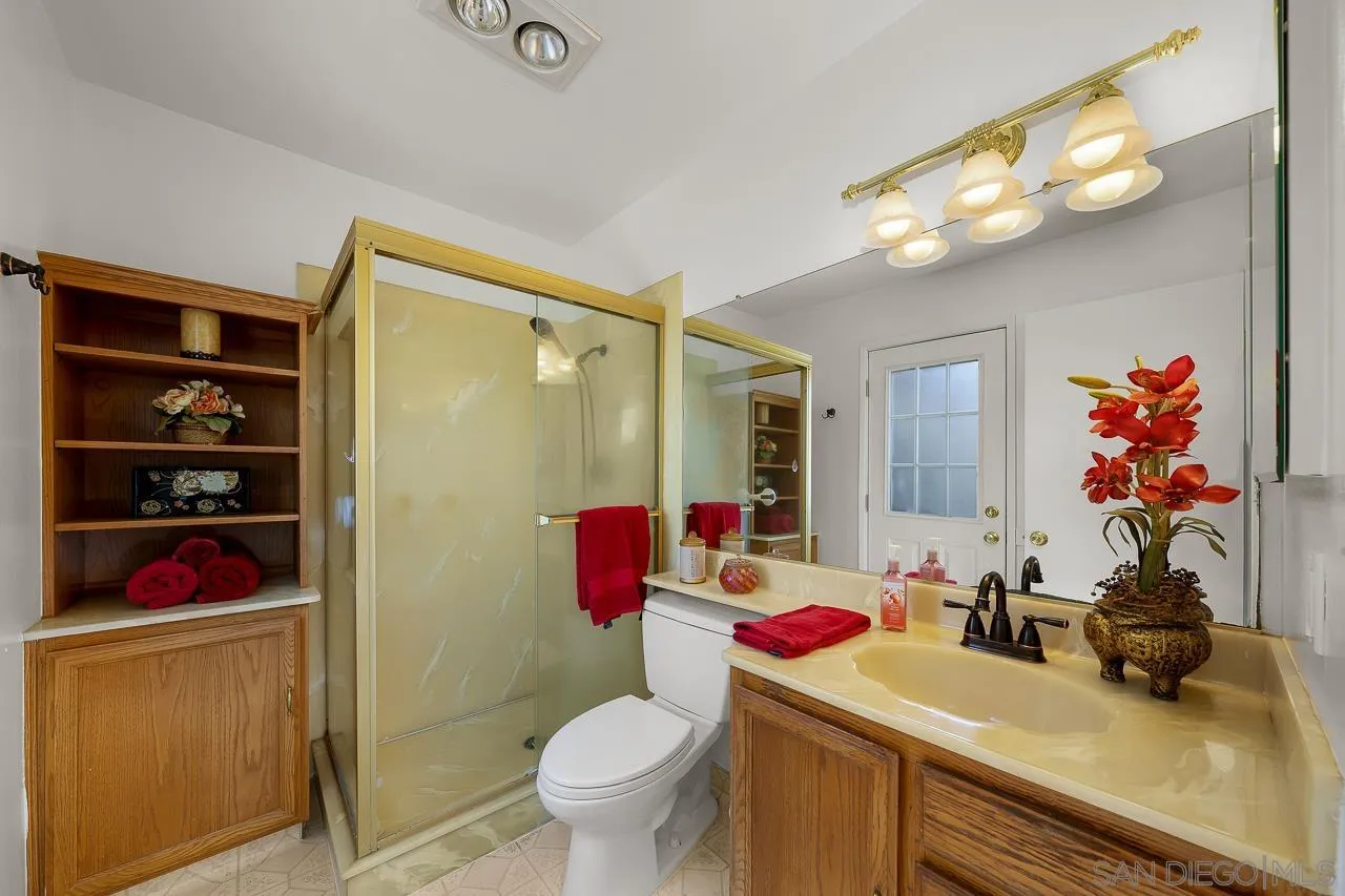 2711 South Barcelona Street Spring Valley, CA 91977 - Photo 21 of 38 a bathroom with a sink mirror vanity and toilet