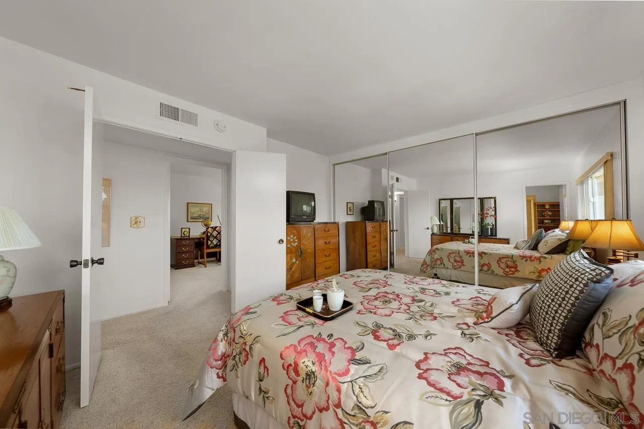 2711 South Barcelona Street Spring Valley, CA 91977 - Photo 22 of 38 a bedroom with a bed and a large mirror