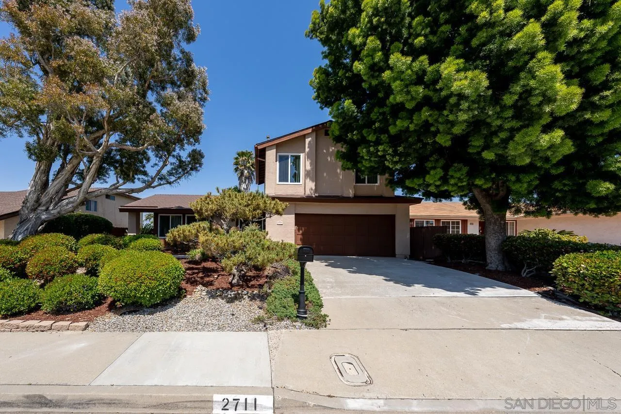 2711 South Barcelona Street Spring Valley, CA 91977 - Photo 38 of 38 a wooden bench sitting in front of a house