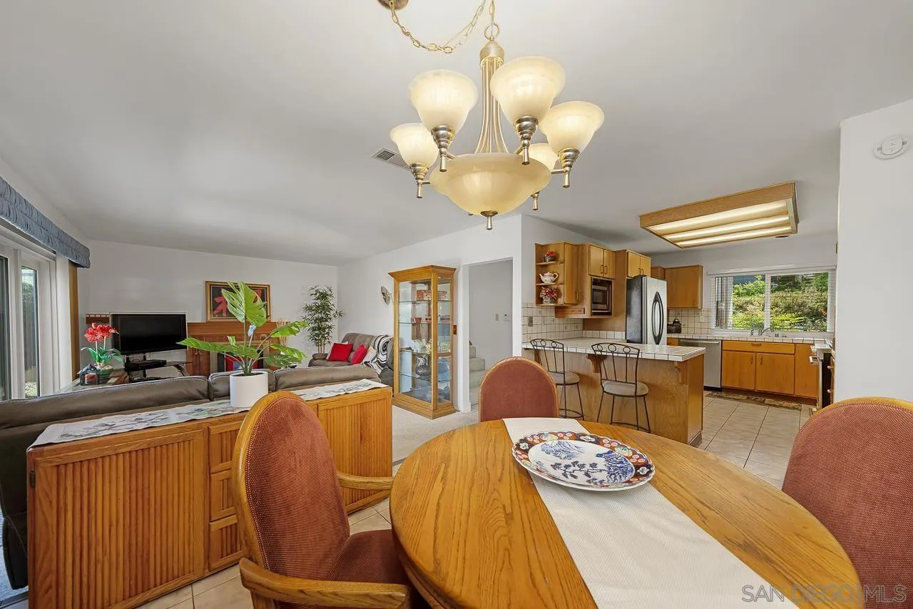 2711 South Barcelona Street Spring Valley, CA 91977 - Photo 6 of 38 a view of a dining room with furniture a chandelier and wooden floor