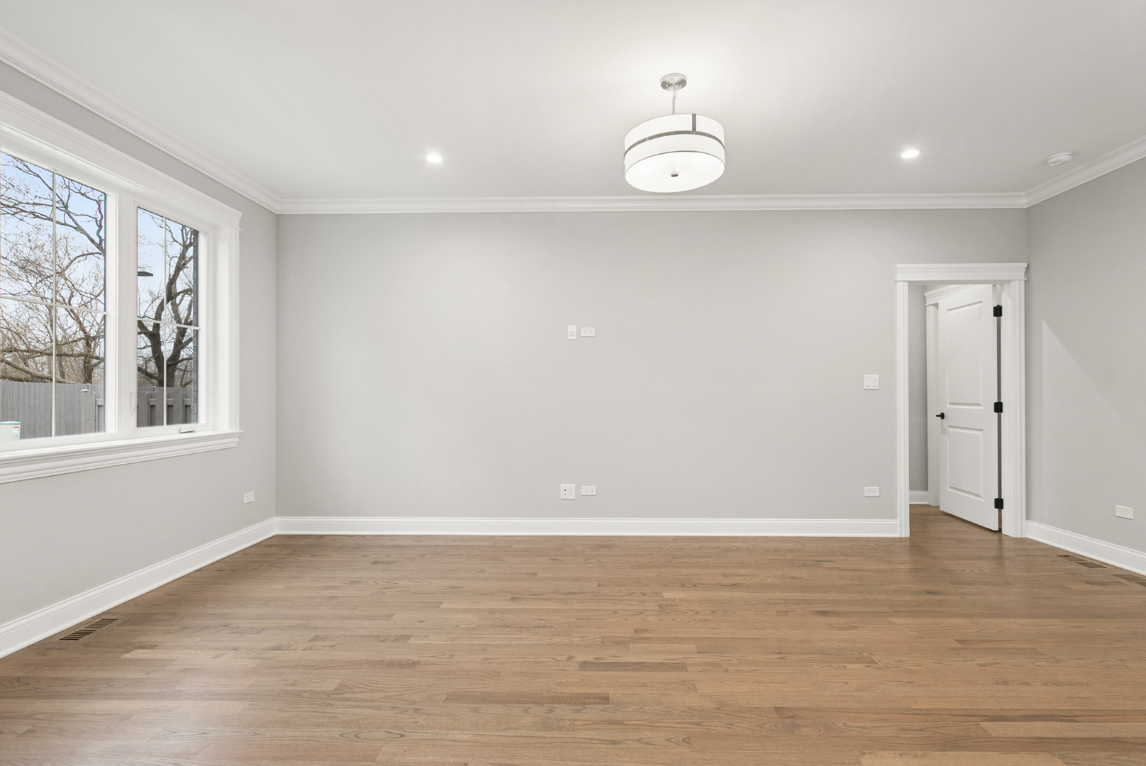 11323 1st Street Mokena, IL 60448 - Photo 11 of 26 a view of an empty room with wooden floor and a window