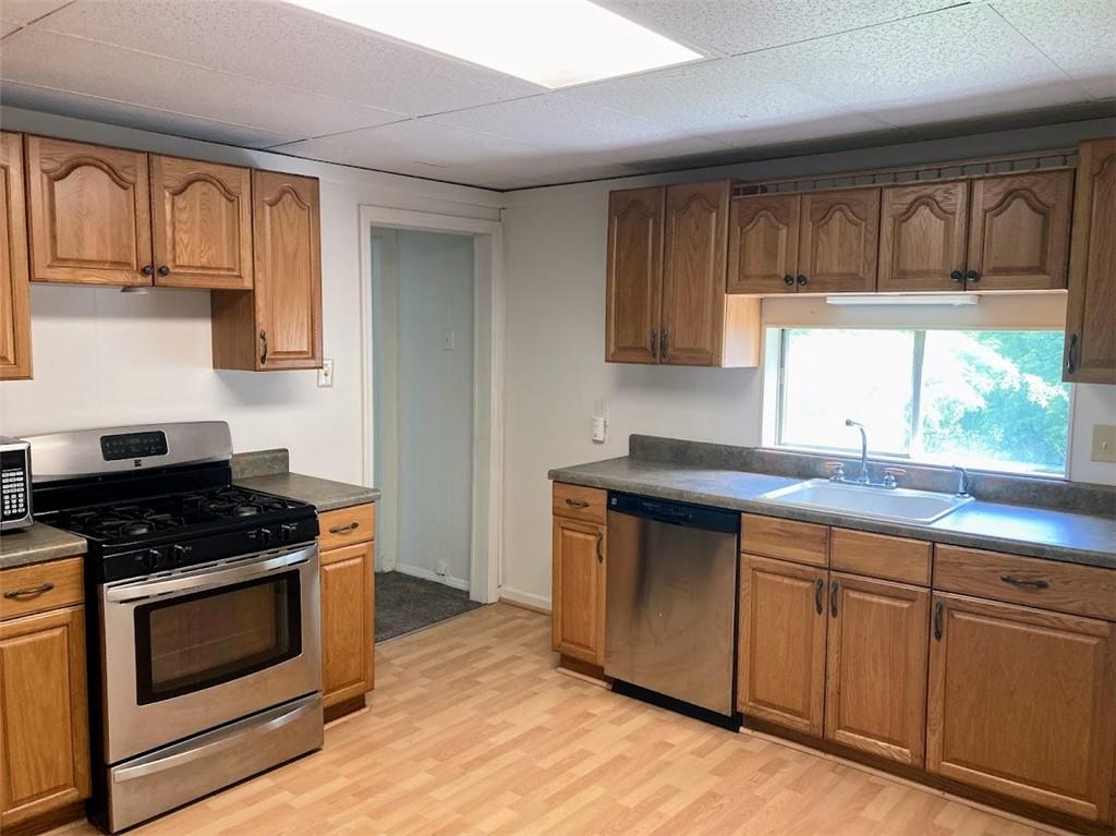 4974 Williamsport Road Elizabeth, PA 15037 - Photo 6 of 34 a kitchen with granite countertop wooden cabinets stainless steel appliances and a window