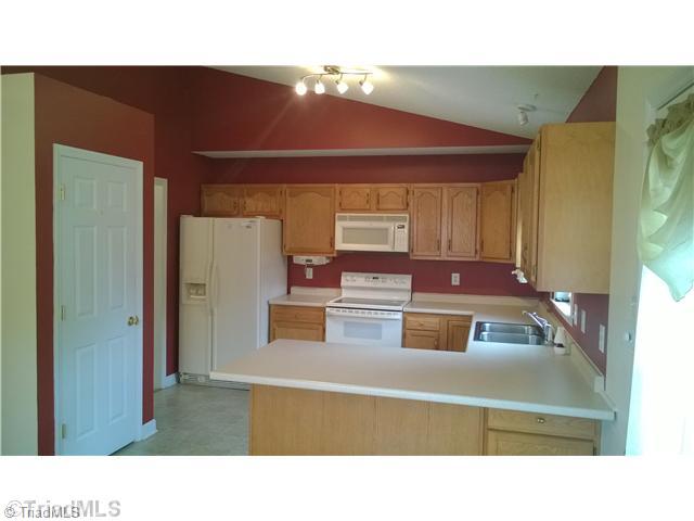 130 Baxter Road Winston-Salem, NC 27107 - Photo 4 of 16 Kitchen. Cathedral ceiling continues in the kitchen.