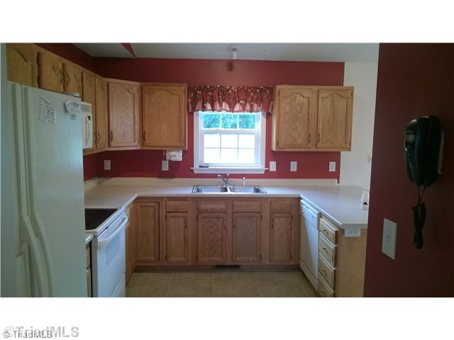 130 Baxter Road Winston-Salem, NC 27107 - Photo 15 of 16 Kitchen. Kitchen features a large pantry and cathedral ceilings with a bar that separates the dining room for an open floor plan.