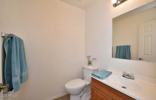 a white toilet sitting next to a bathroom sink