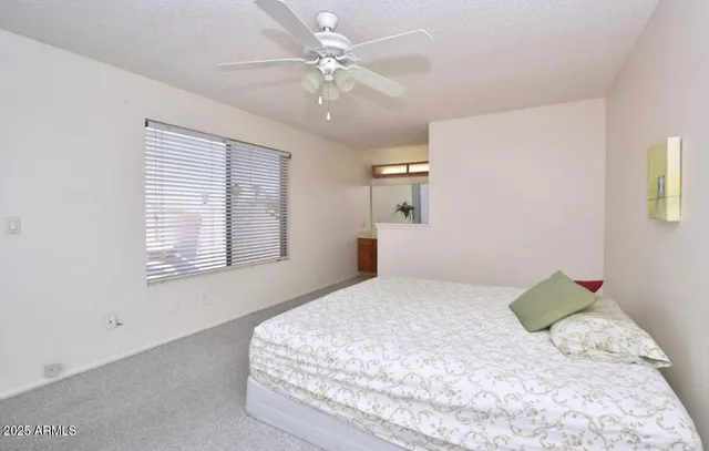 a bedroom with a bed dresser and a window