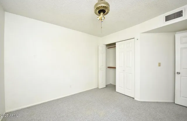 a view of a room with a ceiling fan