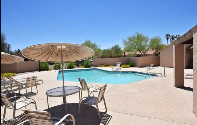 a view of backyard with seating space and wooden floor