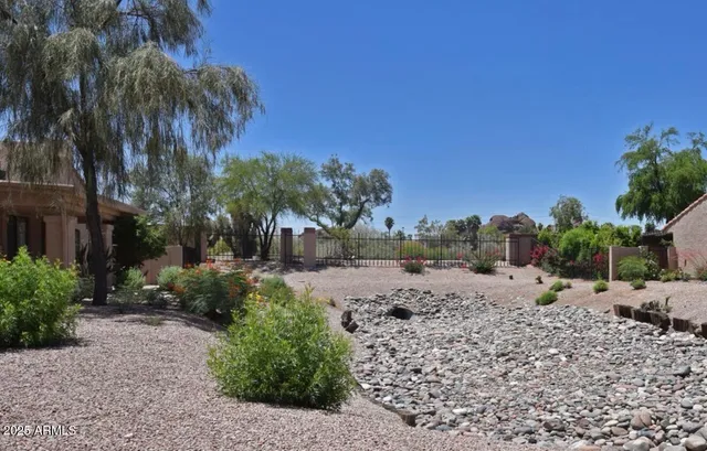 a view of a dirt road and a building in the background