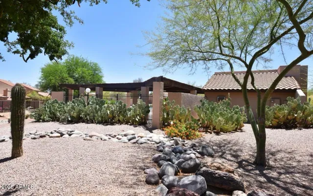 a view of a house with a yard covered in snow