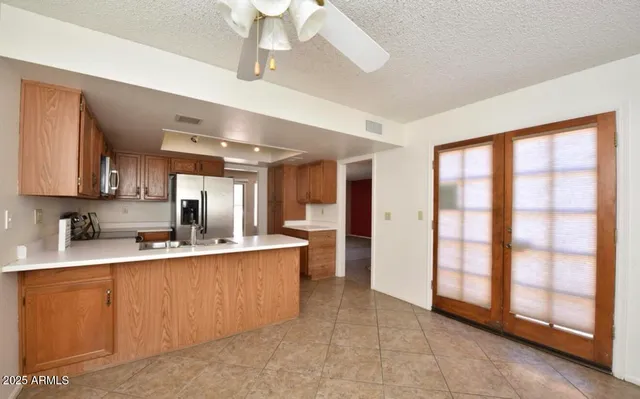 a large kitchen with a large window cabinets and stainless steel appliances