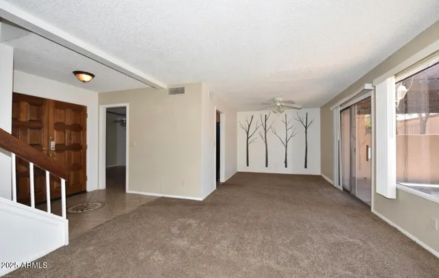 a view of an empty room with large windows