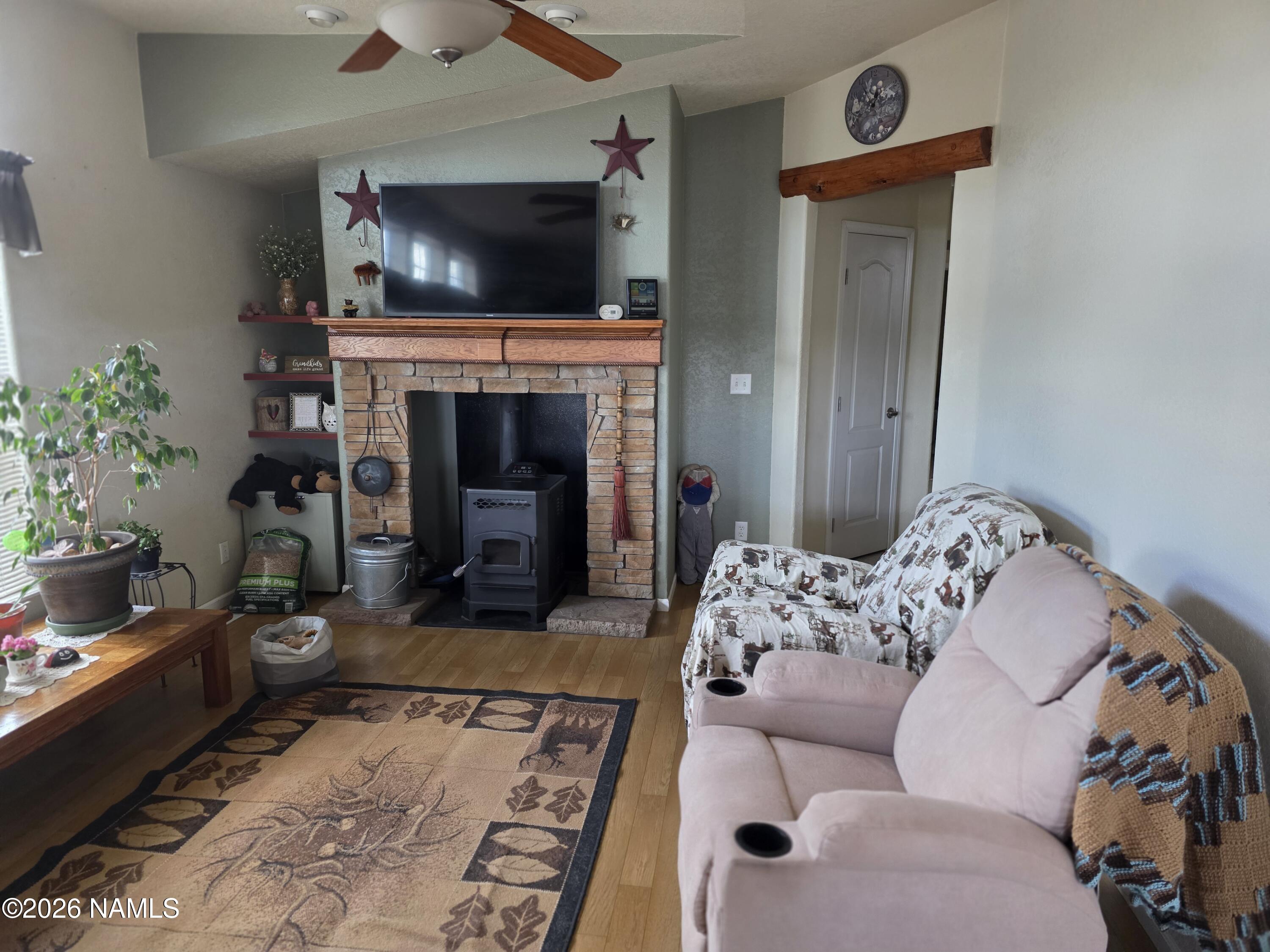 1431 East Cedar Road Williams, AZ 86046 - Photo 20 of 51 a living room with furniture a flat screen tv and a fireplace