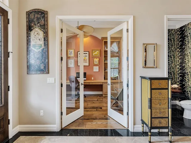 a kitchen with stainless steel appliances granite countertop a sink a stove and a refrigerator