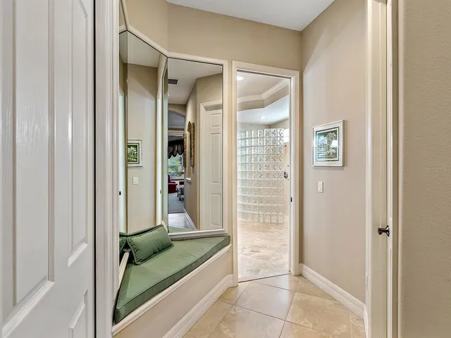 a front view of a house with garden and swimming pool