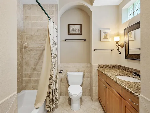 an aerial view of a house with a garden and lake view