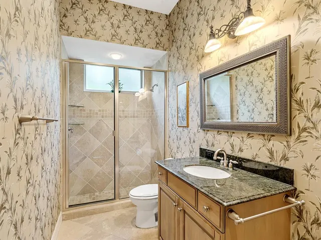 an aerial view of a house with garden space and street view