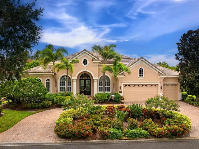 a living room with furniture a fireplace and floor to ceiling windows