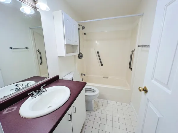 a bathroom with a sink toilet tub and shower