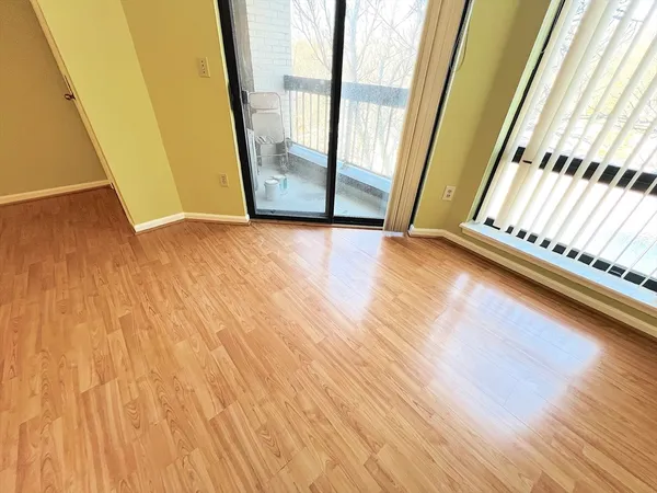 a view of a room with wooden floor and windows